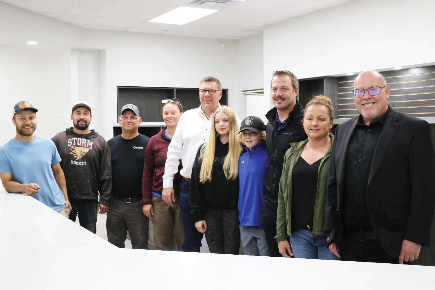 Premier Scott Moe and MLA Kevin Weedmark with pharmacy owner Tyler Thomlinson, family, staff and contractors inside the new pharmacy in Grenfell.